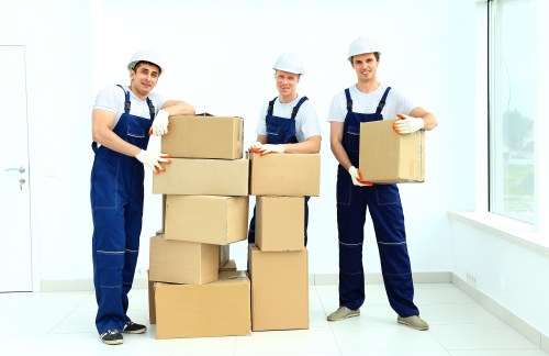 Professional moving team handling furniture during house removals in Roehampton