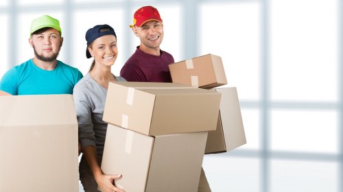 Staff using safe lifting techniques during a house move