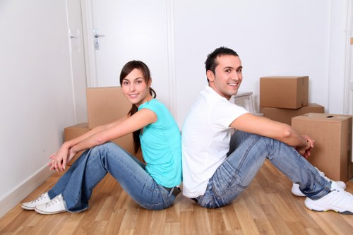 Professional movers transporting furniture during a house removal