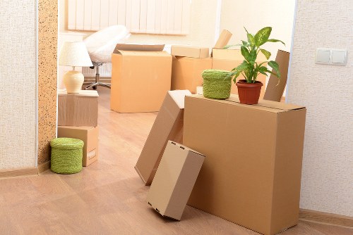 A moving team handling boxes and furniture in a Roehampton street