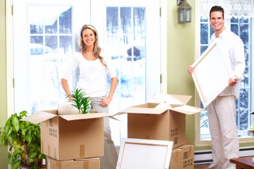 Business relocation logistics in Roehampton with moving van and packed office items