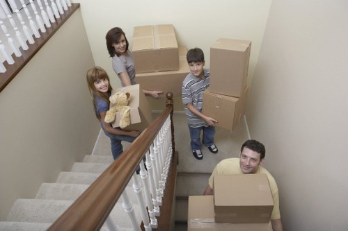 Removal movers loading fragile household items for a Roehampton home move